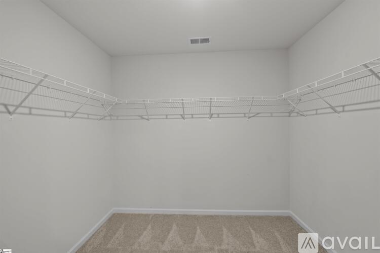 Empty room with white walls and a carpeted floor.