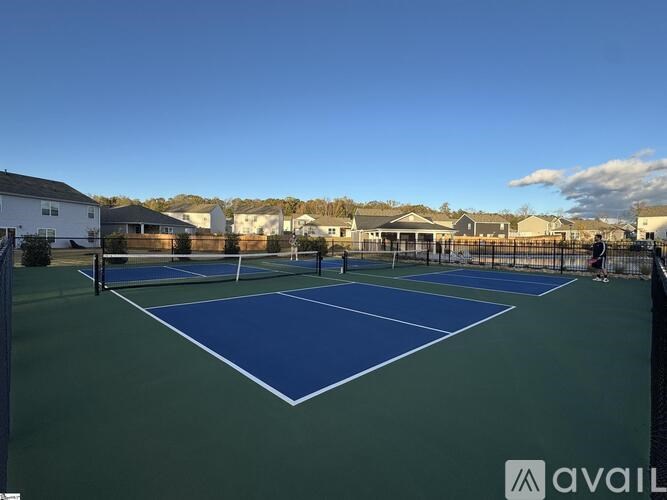 A tennis court with a blue and green surface and white lines.
