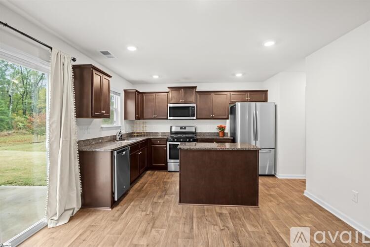 A kitchen with brown cabinets and a wooden island.