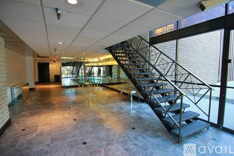 A large open space with a staircase and a brick wall.