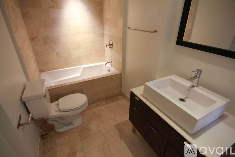 A bathroom with a toilet, sink, and bathtub.