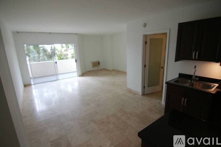 A kitchen area with a sink and a window.