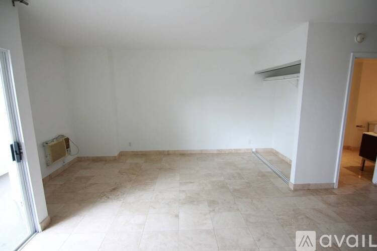 A room with a tiled floor and a door on the left.