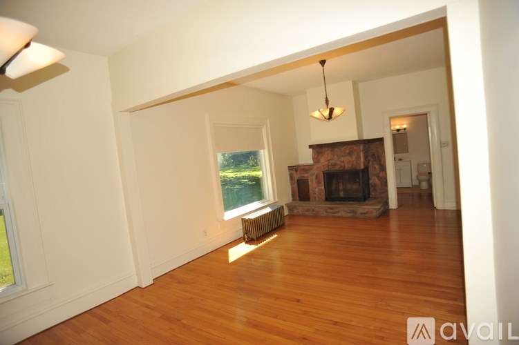A living room with a fireplace and a large window.