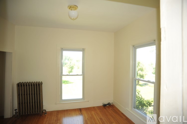 A room with a window and a radiator on the wall.