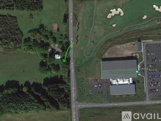 A satellite image shows a road intersection with a green arrow pointing to a building.