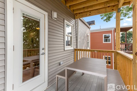 A wooden deck with a table and chairs is available for rent.