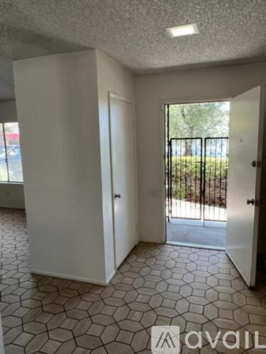 A room with a tiled floor and a door leading outside.