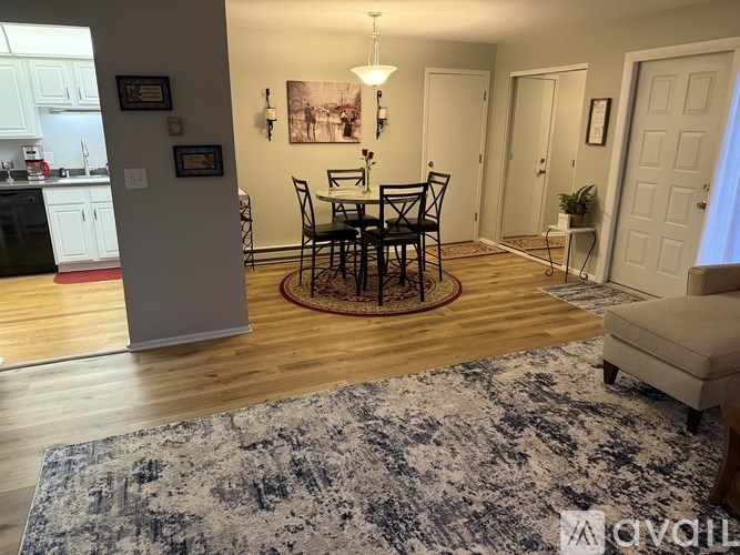 A dining room with a table set for four.