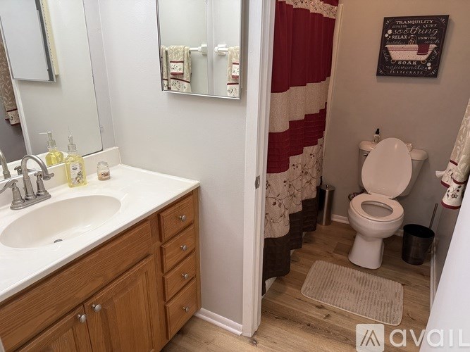 A bathroom with a white sink and a toilet.