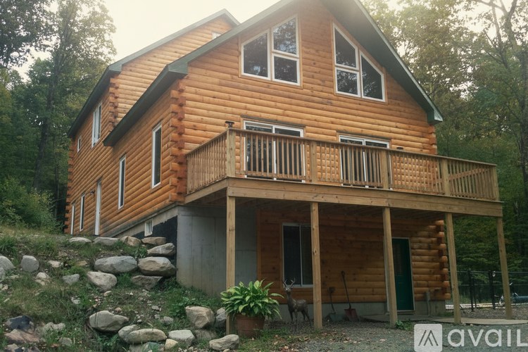 A wooden house with a balcony and a green door.