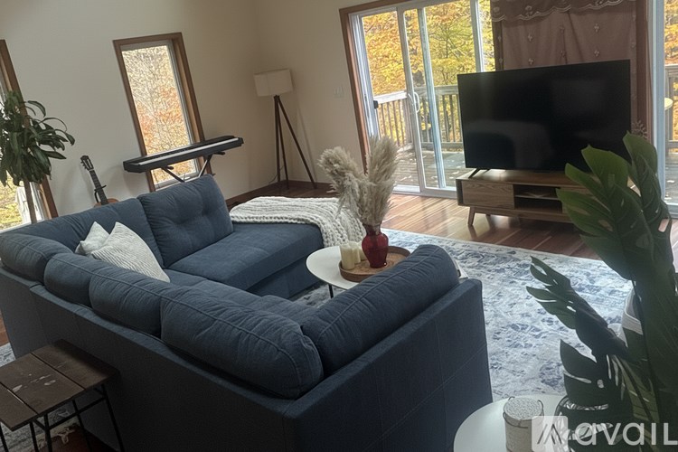 A living room with a blue couch and a television.