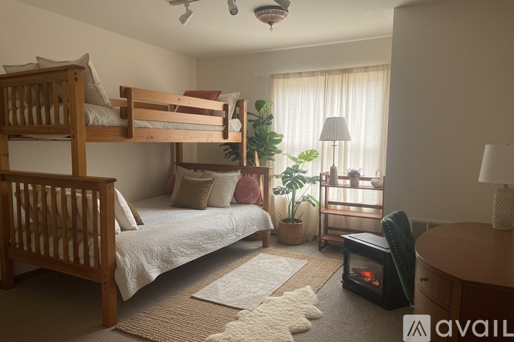 A cozy bedroom with a bunk bed and a small table.