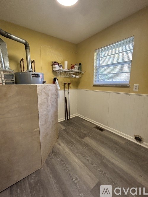 A room with a window and a sink.