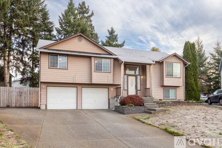 A two-story house with a garage is for sale.