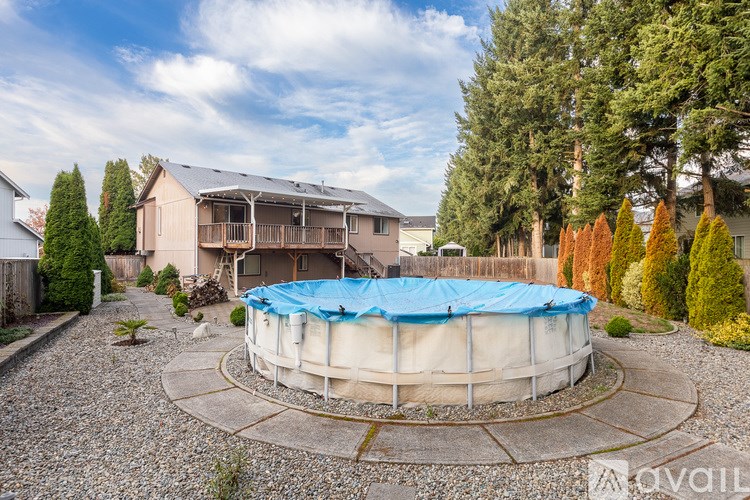 A house with a round pool in the backyard.