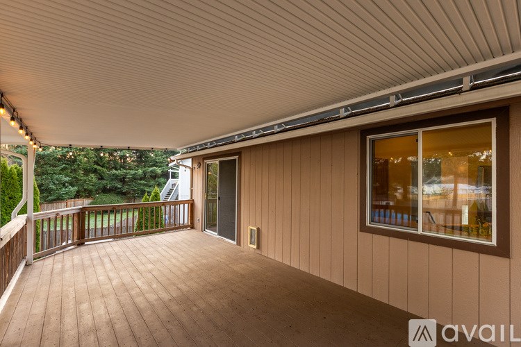 A balcony with a wooden floor and a ceiling with a corrugated texture.