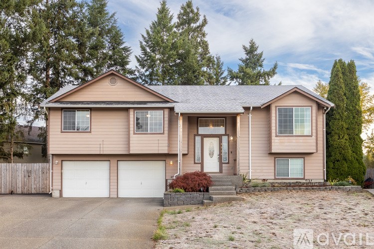 A two-story house with a garage is available for rent.