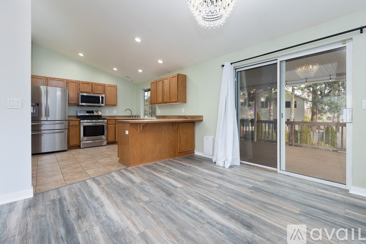 A kitchen with wooden cabinets and a large island.