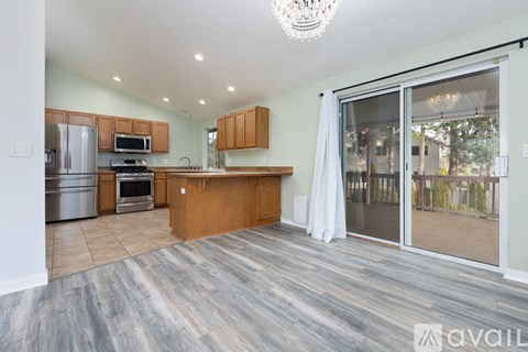 A kitchen with wooden cabinets and a large island.