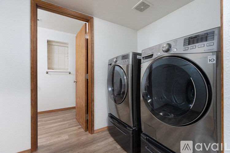 A washing machine and dryer in a laundry room.
