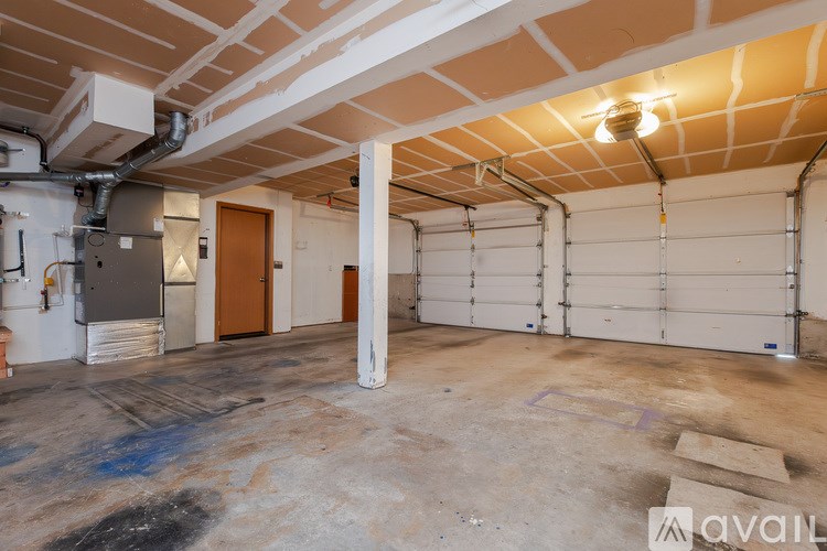A large empty garage with a white ceiling and walls.