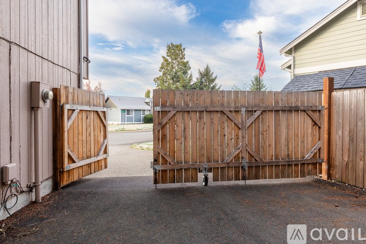 A wooden gate with a metal handle is closed.