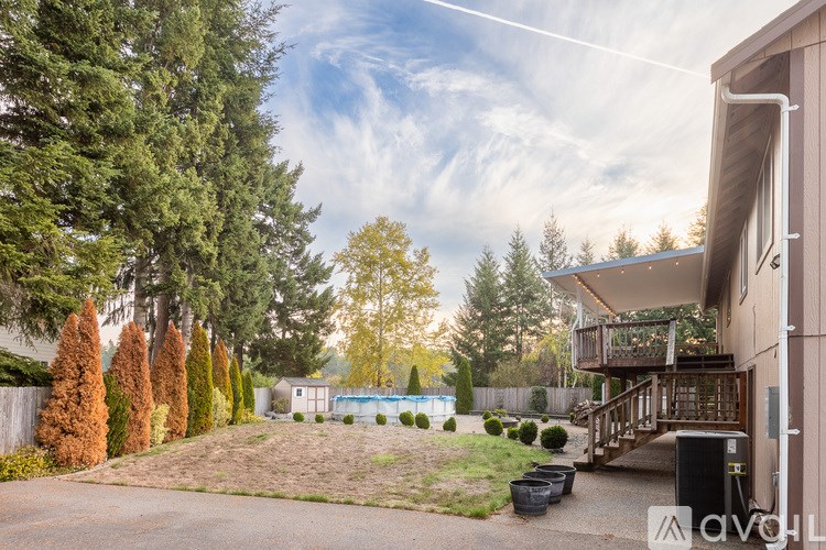 A backyard with a pool and a deck.