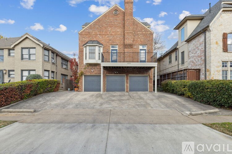 A large brick house with a garage is in the foreground.