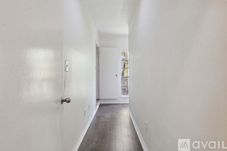 A long hallway with a door at the end.