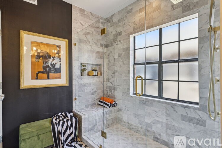 A bathroom with a marble wall and a window.