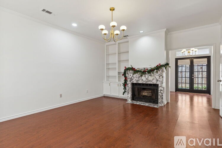 A living room with a fireplace and a chandelier.