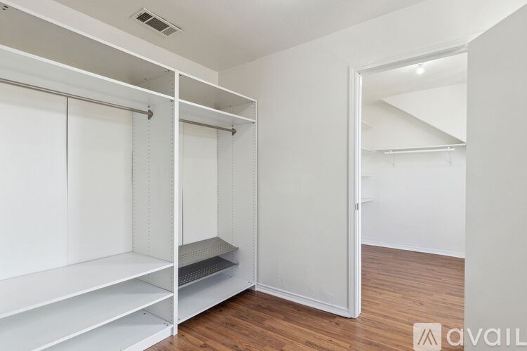 A white room with a bunk bed and a door.