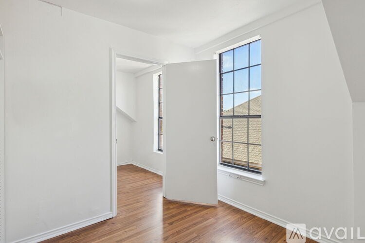 A room with a window and a door.