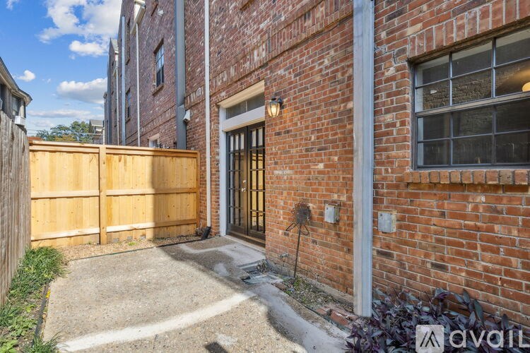 A brick building with a wooden fence and gate.