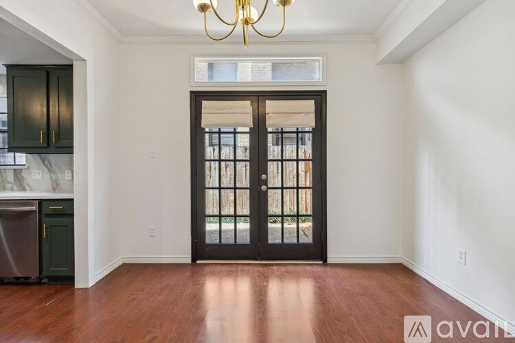 A room with a wooden floor and a chandelier.