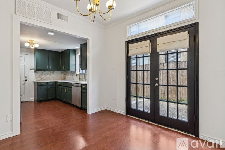 A room with a wooden floor and a chandelier.