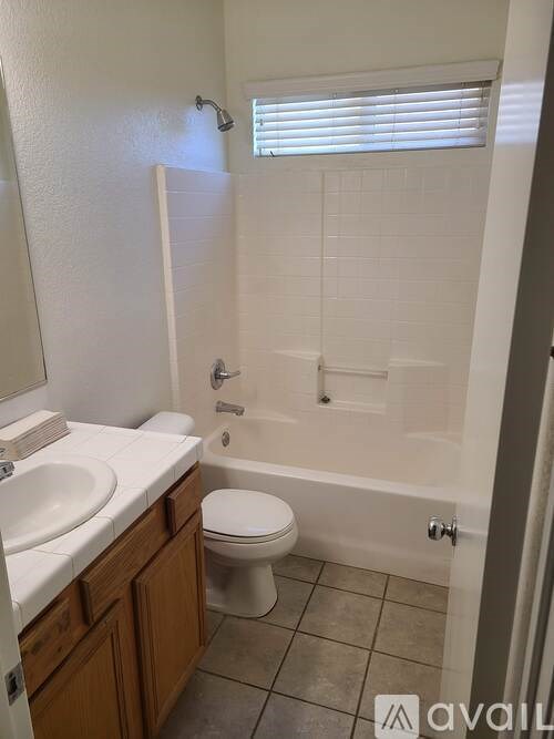 A bathroom with a toilet, sink, and bathtub.