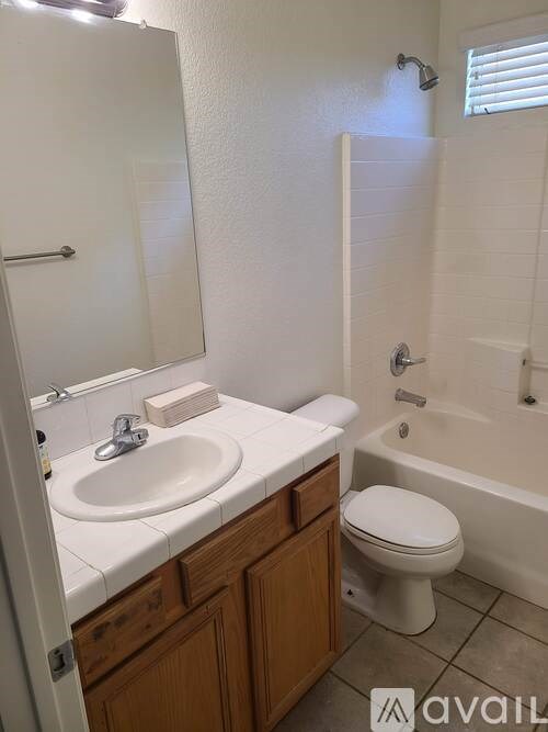 A bathroom with a toilet, sink, and bathtub.