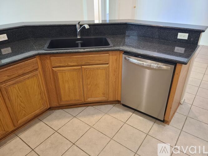 A kitchen with a sink and a dishwasher.