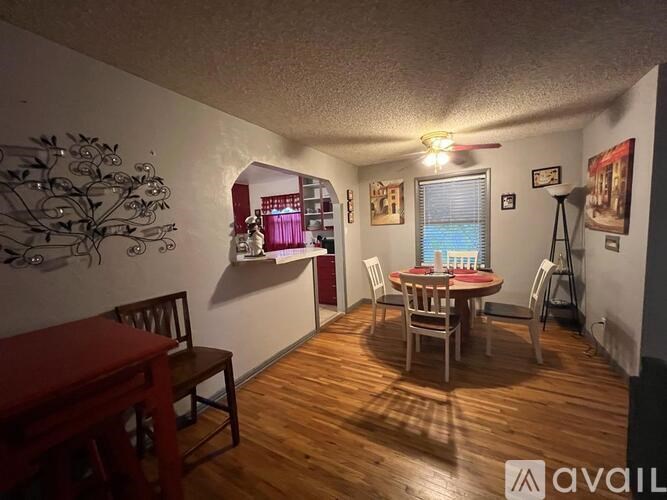 A dining room with a wooden table and chairs.