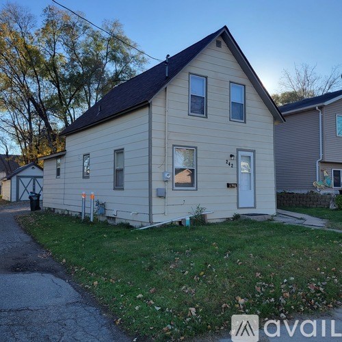 A small house with a white door and windows is shown.