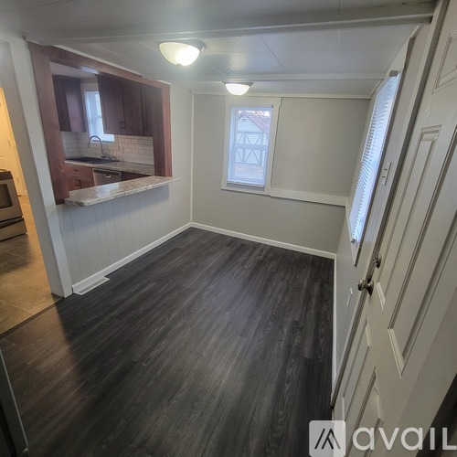 A room with wooden floors and a window.
