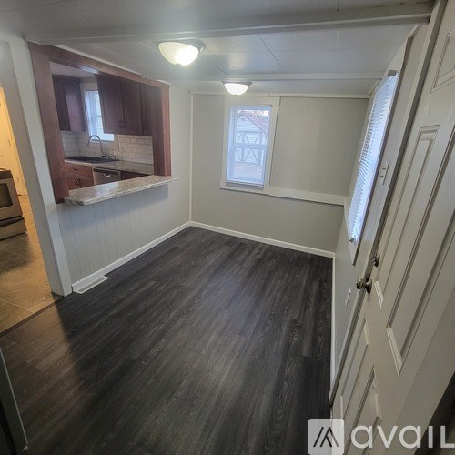 A room with wooden floors and a window.