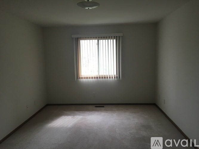 A room with a window and a ceiling light.