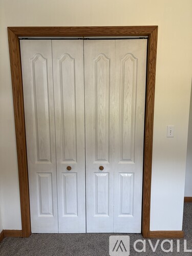 A white double door with a wooden frame.