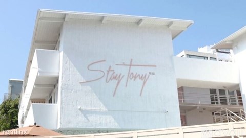 A white building with a sign that says "Stay Fancy".