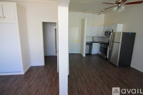 A kitchen with a refrigerator, microwave, and oven.