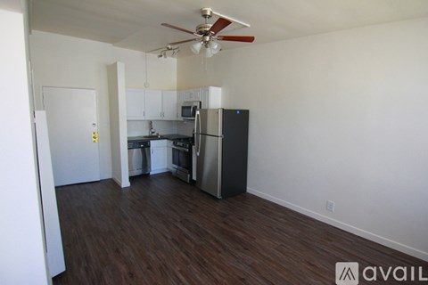 A kitchen with a refrigerator, oven, and microwave.