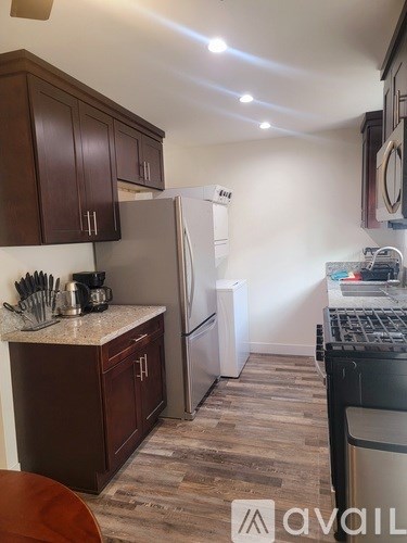 A kitchen with a white fridge and wooden cabinets.